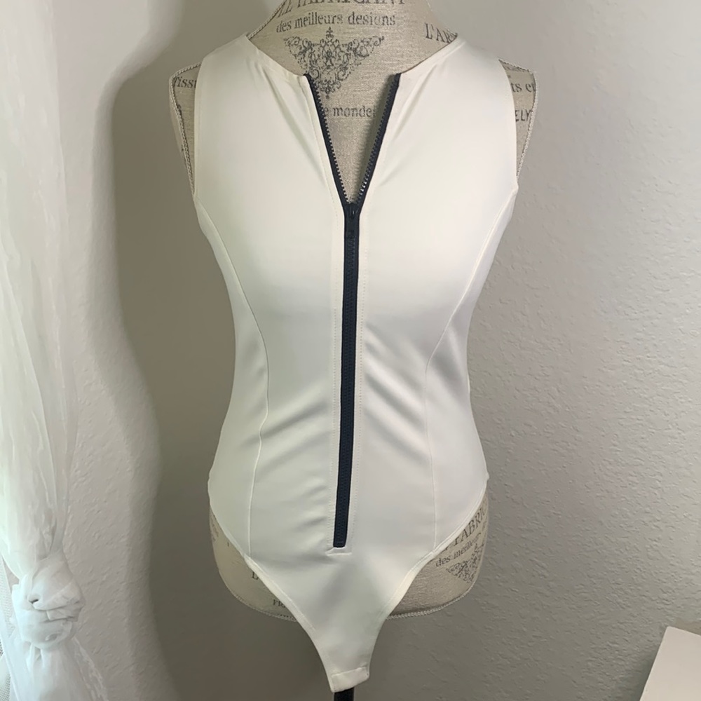 Forever21 White bodysuit with black front zipper.